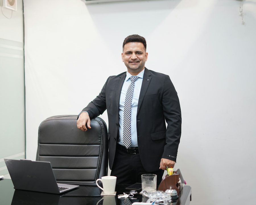 A manager standing at his office desk